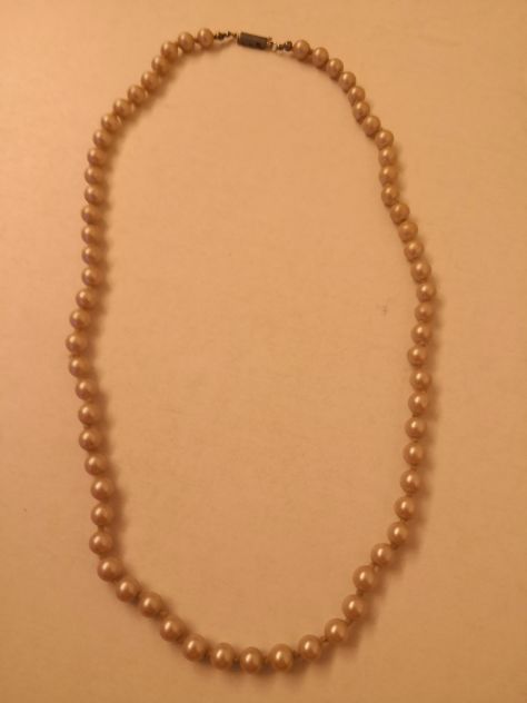 Collana con perle di bigiotteria con fermaglio.