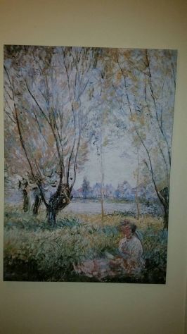 Woman seated under the willows di Claude Monet