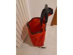 Carrello per spese di colore rosso, marchiato COOP, capiente,due ruote,perfetto.