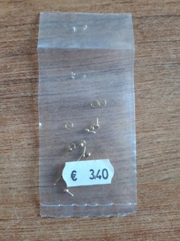 Sacchetto chiodi in ottone con testa sferica bucata con anello passante